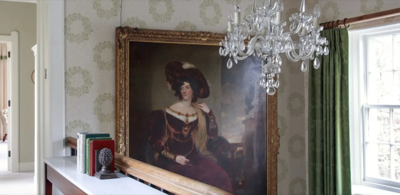 A portrait-lined hallway at Abbotsford